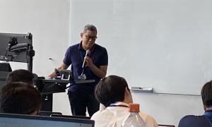 Meeting Room:  Speakers in front of attendees, slides behind speakers 